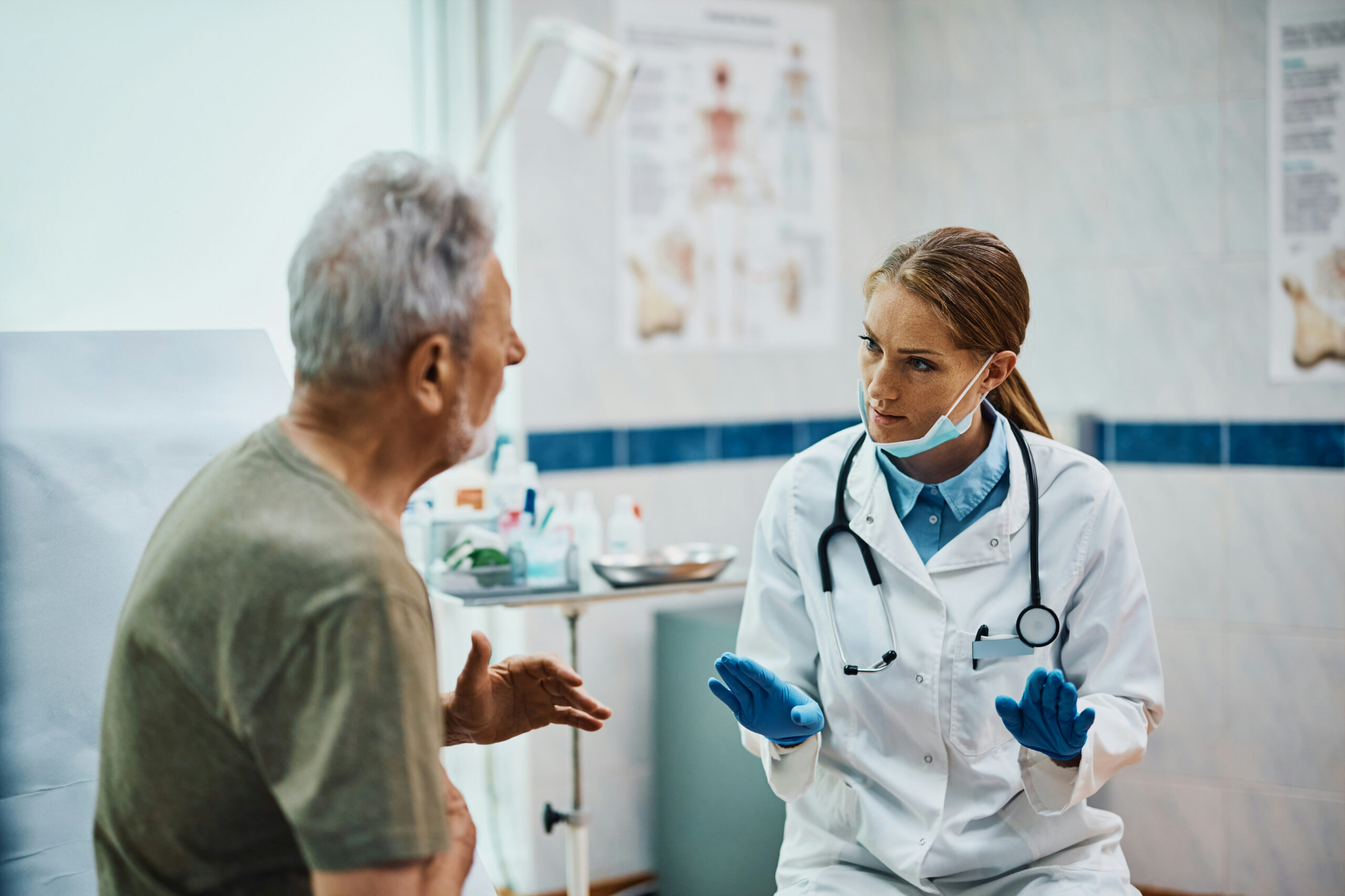 Nephrology provider discussing chronic kidney disease care with an older patient during a clinic visit