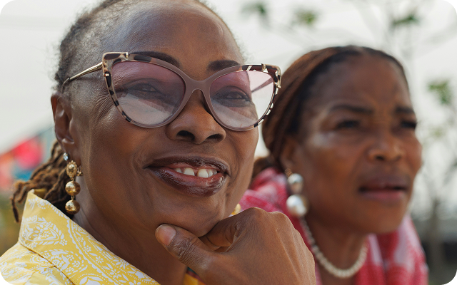 Two older women smiling outdoors, representing patients sharing positive kidney care experiences