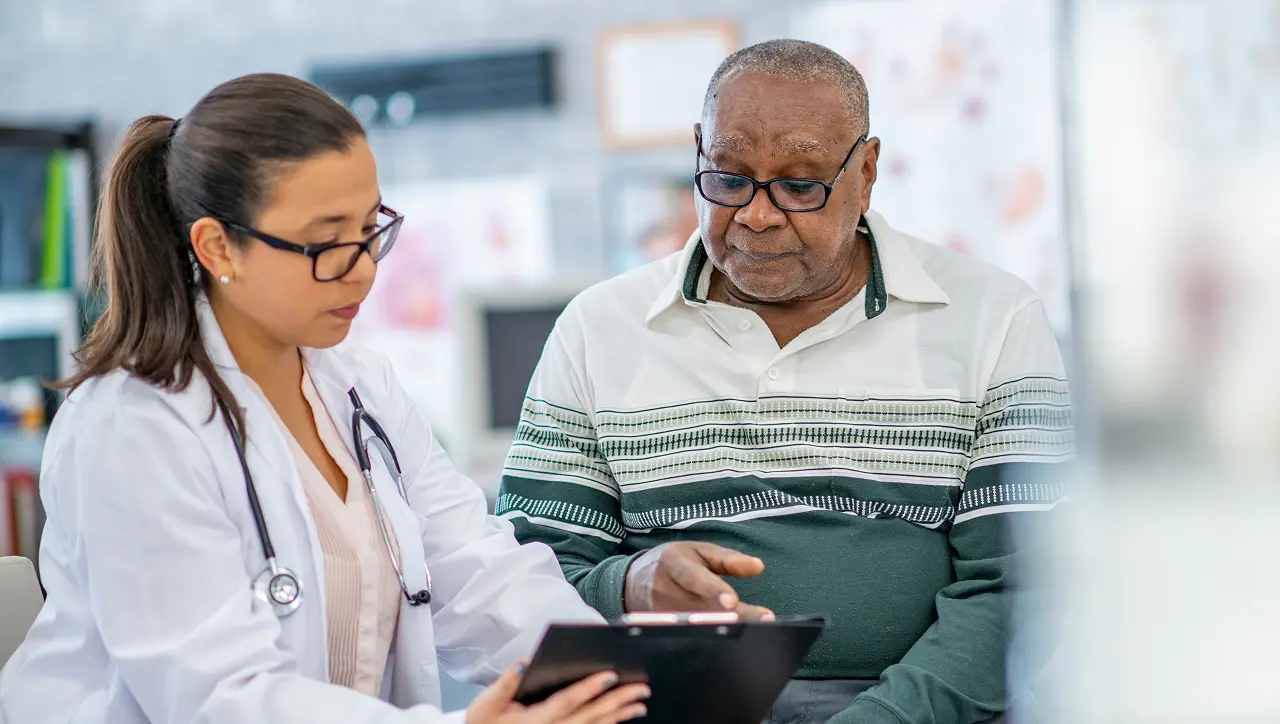 KSM physician talking with patient in clinic